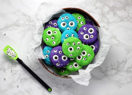 Colourful cookies with stick-on eyeballs making them look like cookie monsters.