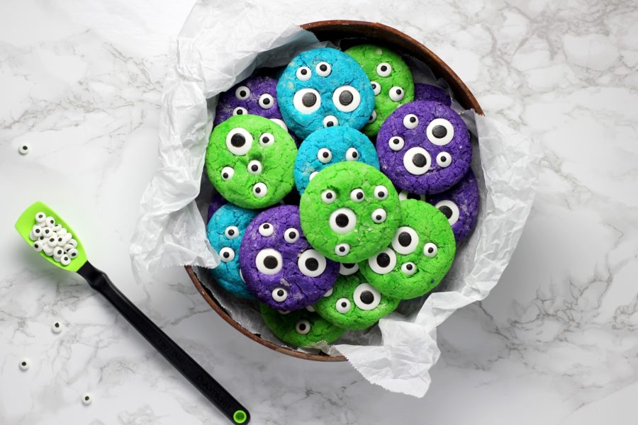 Colourful cookies with stick-on eyeballs making them look like cookie monsters.