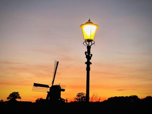 Autumn sunset shot of a windmill and antique lamp in Netherlands.