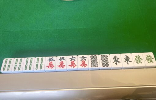 A hand of mahjong showing 6 sets of doubles laid out on mahjong table. 