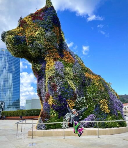 Famous Puppy sculpture decorated with flowers in front of Guggenheim Museum in Bilbao, Spain.