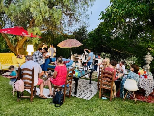 Group of friends in a compound, eating, chatting and dancing.