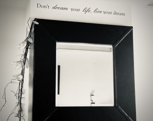 Writing on a wall "Don't dream your life; live your dream."