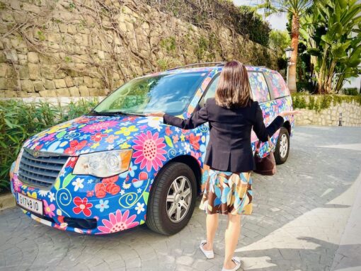 Car with colourful blooms painted all over. 