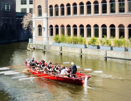 Rowers hard at work in an Amsterdam canal.