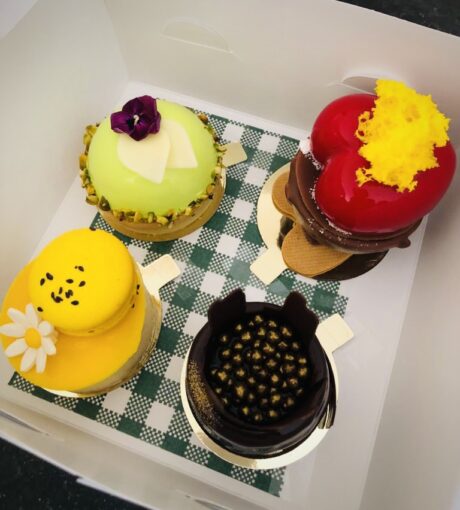 Box of delightful colourful cupcakes. 