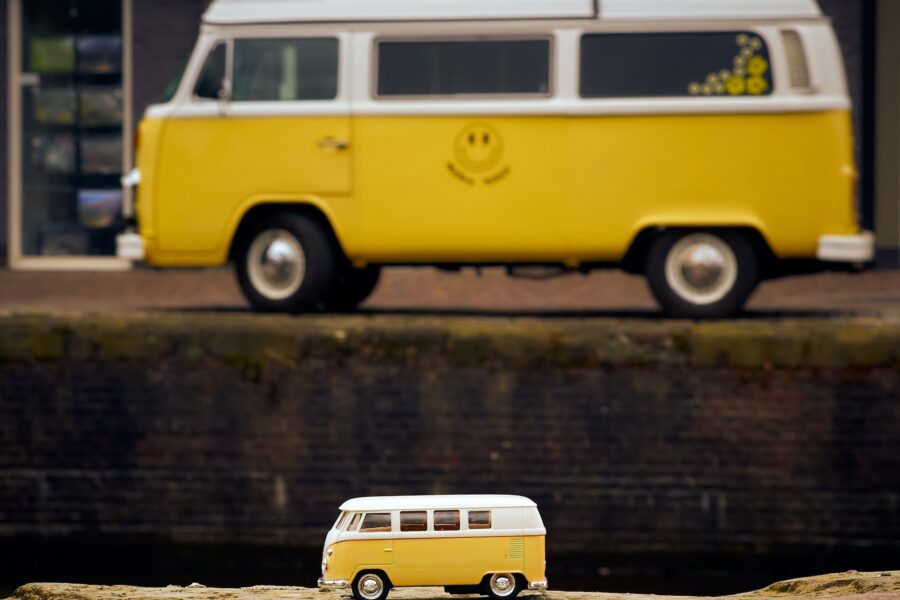 Model Volkswagen van photographed in front of the actual van, both in yellow.