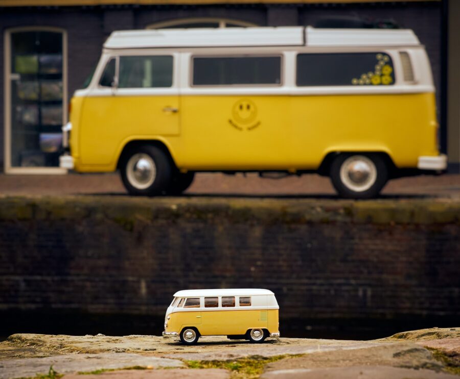 Model Volkswagen van photographed in front of the actual van, both in yellow.