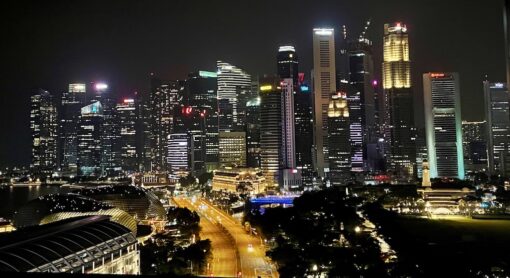 Singapore central business district at nighttime, still busy with office lights on.