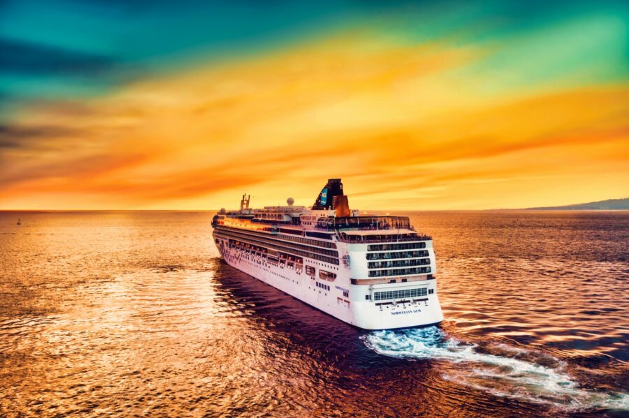 Cruise liner sailing into sunset.