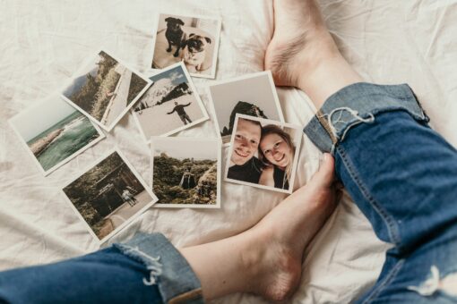 Vacation photos on a bed, as a show of nostalgia.