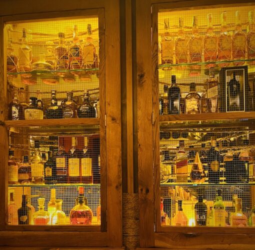 Cupboard filled with hard liquor with backlit.