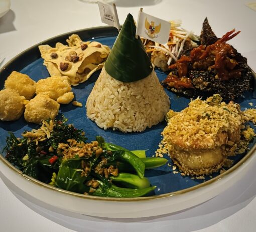 Indonesian rijstafel - various dishes served with a tower of rice. 