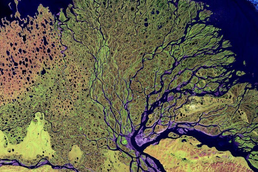 Aerial view of Lena River meandering through colourful surrounding areas.