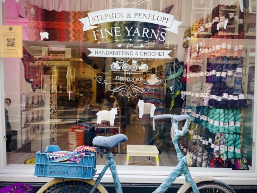 Shopfront of a yarn shop with a bicycle parked in front. 